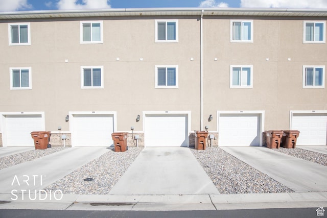 43 E 670 N, Vineyard, UT 84059 - back of property with stucco siding, a garage, and driveway
