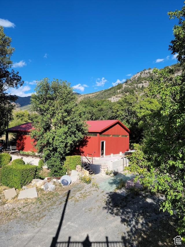 97 Main St, Ophir, UT 84071 - view of side of property with a pole building, a mountain view, and an outbuilding