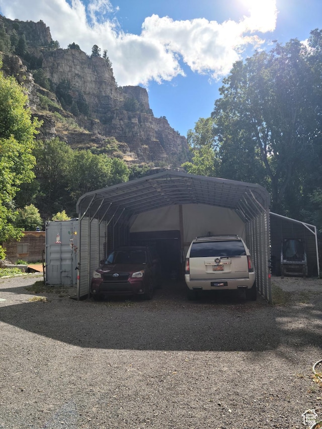 97 Main St, Ophir, UT 84071 - view of vehicle parking featuring a carport, driveway, and a mountain view