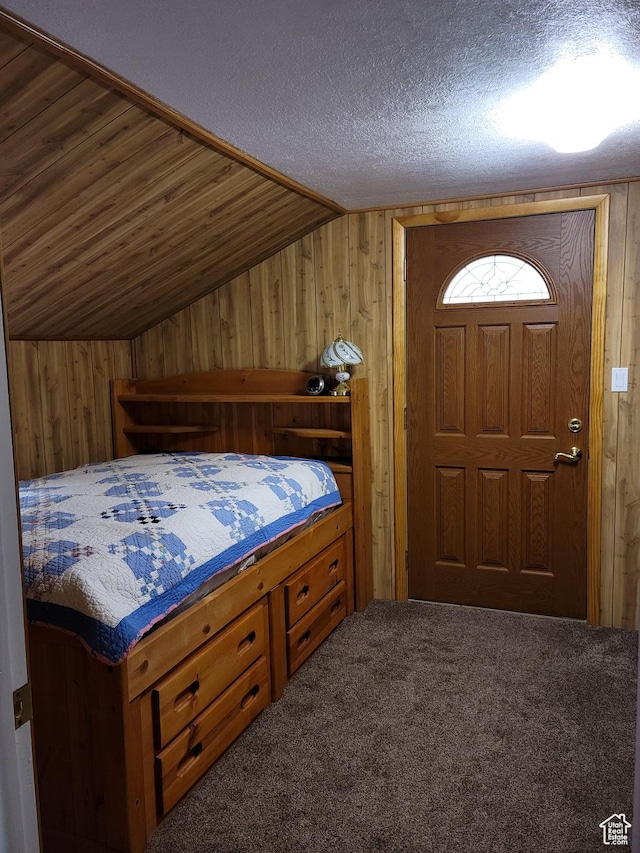 97 Main St, Ophir, UT 84071 - bedroom with wooden walls, vaulted ceiling, carpet, and a textured ceiling