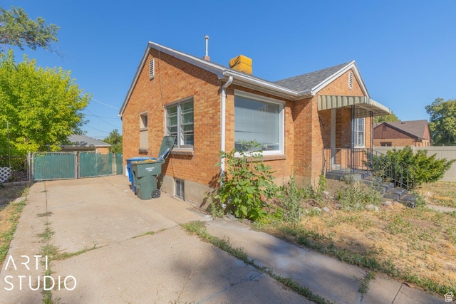 3317 Jackson Ave, Ogden, UT 84403 - view of front of house featuring brick siding, a chimney, and a gate