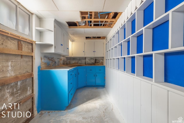 3317 Jackson Ave, Ogden, UT 84403 - kitchen with open shelves, unfinished concrete flooring, and blue cabinets