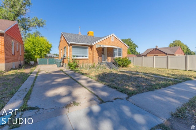 3317 Jackson Ave, Ogden, UT 84403 - bungalow-style house with brick siding, a gate, driveway, and a chimney