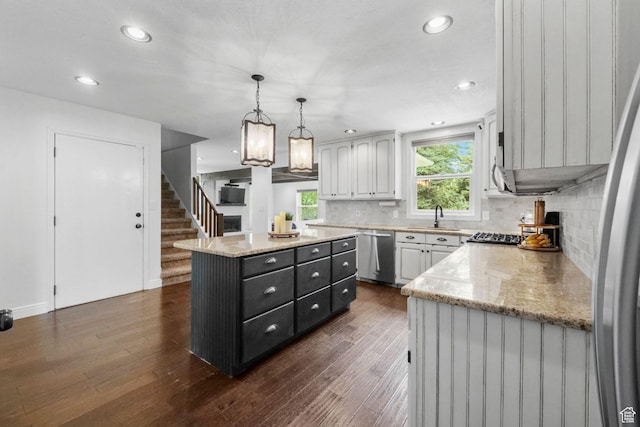 578 S 750 E, Bountiful, UT 84010 - kitchen with dishwasher, a center island, dark wood-type flooring, decorative backsplash, and decorative light fixtures