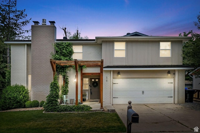 578 S 750 E, Bountiful, UT 84010 - view of front of property featuring brick siding, driveway, a chimney, an attached garage, and a lawn