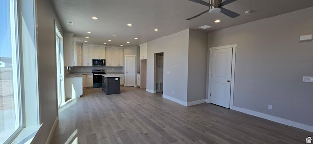 201 W 1300 S, Tremonton, UT 84337 - kitchen featuring stainless steel range with electric cooktop, recessed lighting, open floor plan, a ceiling fan, and wood finished floors