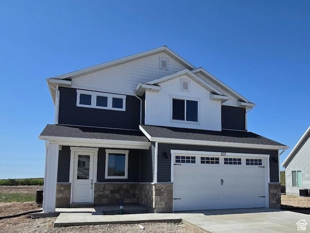 201 W 1300 S, Tremonton, UT 84337 - craftsman-style house featuring stone siding, a garage, driveway, and roof with shingles