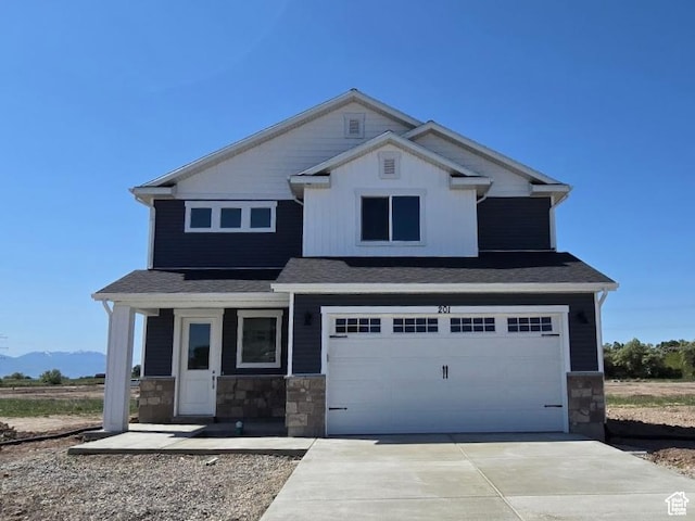 201 W 1300 S, Tremonton, UT 84337 - craftsman-style house featuring stone siding, a garage, concrete driveway, and a mountain view