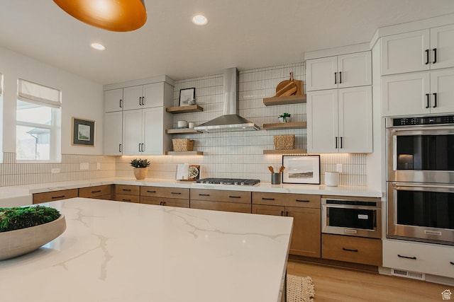 3488 E 1120 S Unit 115, Spanish Fork, UT 84660 - kitchen with stainless steel double oven, wall chimney exhaust hood, open shelves, gas stovetop, and recessed lighting