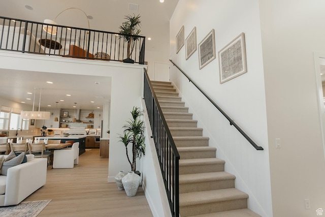 3488 E 1120 S Unit 115, Spanish Fork, UT 84660 - stairs with wood finished floors, a towering ceiling, and recessed lighting