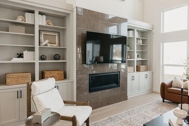 3488 E 1120 S Unit 115, Spanish Fork, UT 84660 - living room with a fireplace, built in shelves, and light wood-type flooring