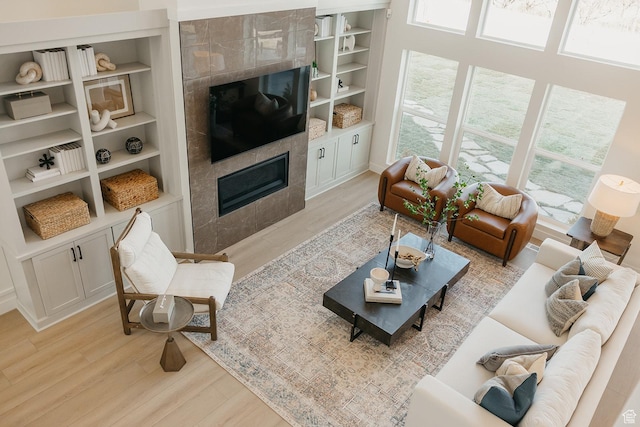3488 E 1120 S Unit 115, Spanish Fork, UT 84660 - living area featuring a tiled fireplace, light wood-style flooring, and built in shelves