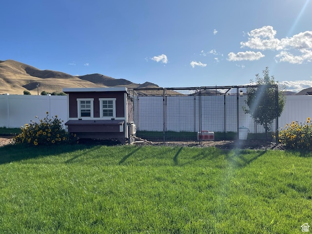 70 W 1790 N, Genola, UT 84655 - rear view of house with a fenced backyard, an outbuilding, exterior structure, and a mountain view