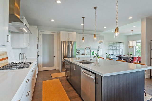 68 E Columbus Ct, Salt Lake City, UT 84103 - kitchen with wall chimney range hood, stainless steel appliances, dark wood-type flooring, light countertops, and recessed lighting