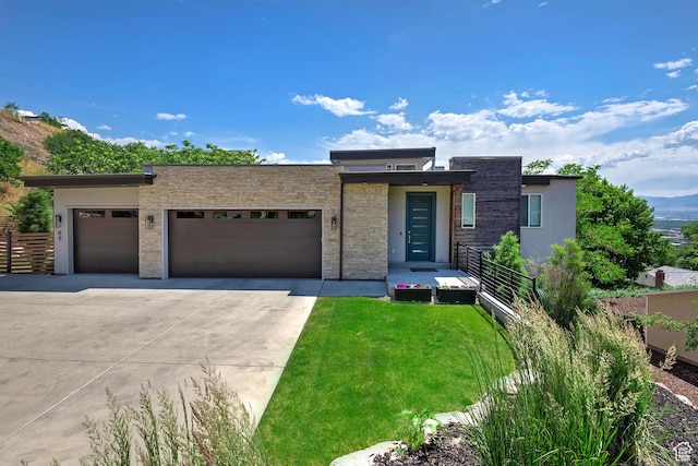 68 E Columbus Ct, Salt Lake City, UT 84103 - contemporary house featuring a garage, driveway, stone siding, a front yard, and stucco siding