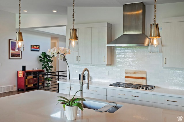 68 E Columbus Ct, Salt Lake City, UT 84103 - kitchen with wall chimney range hood, stainless steel gas stovetop, light countertops, backsplash, and recessed lighting