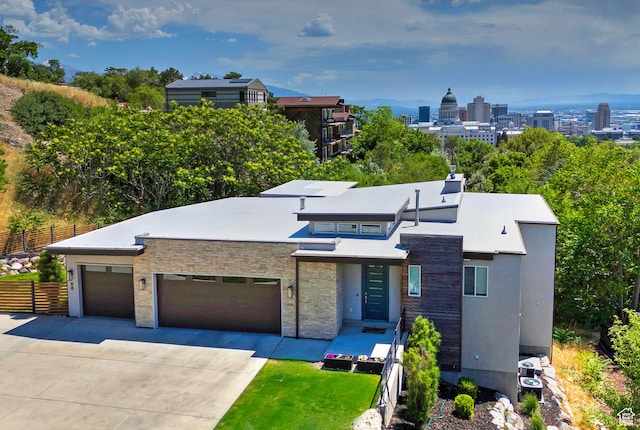 68 E Columbus Ct, Salt Lake City, UT 84103 - modern home featuring driveway, a garage, and stone siding