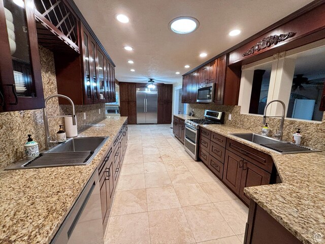 289 W Count Fleet Rd, St George, UT 84790 - kitchen with appliances with stainless steel finishes, backsplash, recessed lighting, light stone counters, and dark brown cabinetry