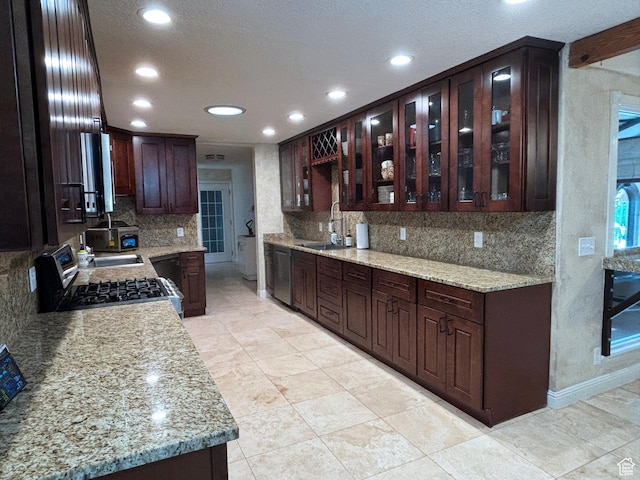 289 W Count Fleet Rd, St George, UT 84790 - kitchen featuring appliances with stainless steel finishes, tasteful backsplash, recessed lighting, dark brown cabinets, and glass insert cabinets