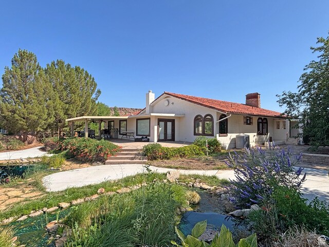 289 W Count Fleet Rd, St George, UT 84790 - rear view of house with a chimney, french doors, and stucco siding