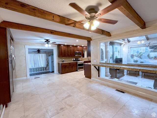 289 W Count Fleet Rd, St George, UT 84790 - kitchen featuring stainless steel appliances, a ceiling fan, beam ceiling, light countertops, and backsplash
