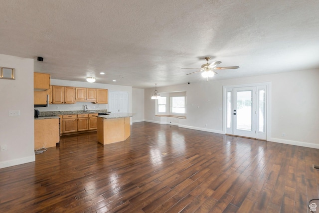 335 W 1410 S, Orem, UT 84058 - kitchen with light countertops, a center island, a ceiling fan, open floor plan, and dark wood-type flooring