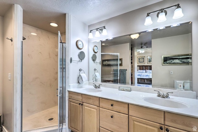 3572 Wild Mare Way, Heber City, UT 84032 - ensuite bathroom featuring double vanity, a stall shower, a ceiling fan, and a textured ceiling