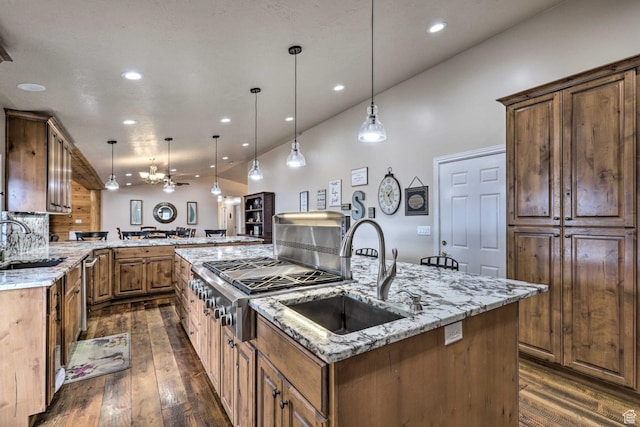 3572 Wild Mare Way, Heber City, UT 84032 - kitchen featuring a kitchen island with sink, dark wood-style flooring, recessed lighting, light stone counters, and pendant lighting