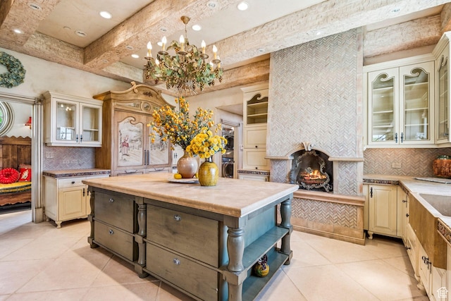 1526 W Red Hawk Trl, Park City, UT 84098 - kitchen featuring light tile patterned floors, tasteful backsplash, cream cabinetry, recessed lighting, and beamed ceiling