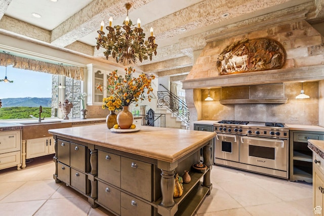 1526 W Red Hawk Trl, Park City, UT 84098 - kitchen featuring range with two ovens, tasteful backsplash, light tile patterned floors, butcher block counters, and beamed ceiling