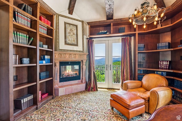 1526 W Red Hawk Trl, Park City, UT 84098 - sitting room with french doors, a tiled fireplace, a chandelier, carpet, and a mountain view