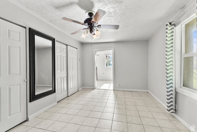 165 N 800 E, Hyrum, UT 84319 - unfurnished bedroom featuring a textured ceiling, light tile patterned flooring, and a ceiling fan