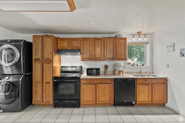 165 N 800 E, Hyrum, UT 84319 - kitchen featuring black appliances, stacked washer / drying machine, brown cabinetry, light countertops, and under cabinet range hood
