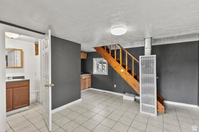 165 N 800 E, Hyrum, UT 84319 - basement featuring a heating unit, stairs, a textured ceiling, and light tile patterned floors