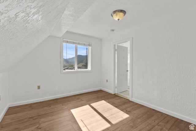 165 N 800 E, Hyrum, UT 84319 - bonus room with a textured ceiling, wood finished floors, and vaulted ceiling