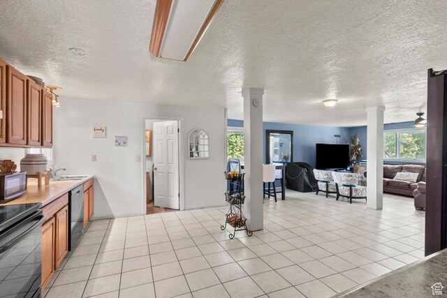 165 N 800 E, Hyrum, UT 84319 - kitchen with black appliances, a textured ceiling, brown cabinetry, open floor plan, and light tile patterned floors
