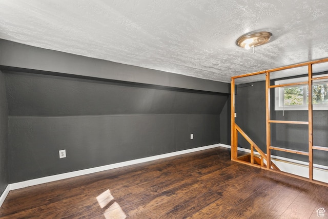 165 N 800 E, Hyrum, UT 84319 - unfurnished bedroom featuring a textured ceiling, hardwood / wood-style floors, and vaulted ceiling