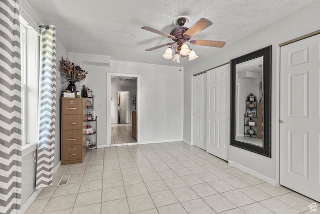 165 N 800 E, Hyrum, UT 84319 - unfurnished bedroom featuring a textured ceiling, light tile patterned floors, and ceiling fan