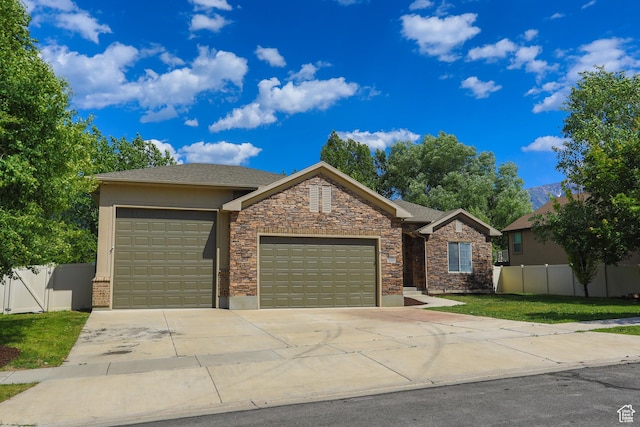 1103 Vista Dr, Santaquin, UT 84655 - view of front of property with an attached garage, driveway, stucco siding, and stone siding