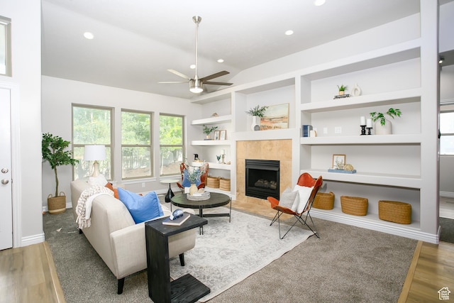 1103 Vista Dr, Santaquin, UT 84655 - living area featuring ceiling fan, built in shelves, a tiled fireplace, recessed lighting, and wood finished floors