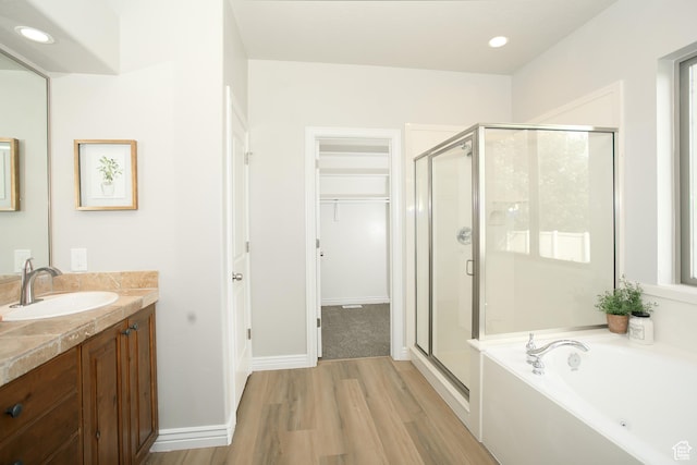 1103 Vista Dr, Santaquin, UT 84655 - bathroom with a stall shower, wood finished floors, vanity, a garden tub, and recessed lighting