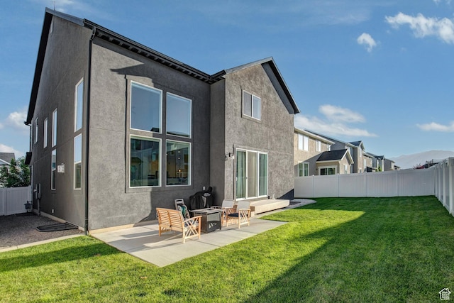 1476 W Stone Gate Dr, Saratoga Springs, UT 84045 - back of house with stucco siding, a patio area, and a fenced backyard