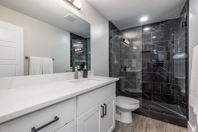 1476 W Stone Gate Dr, Saratoga Springs, UT 84045 - bathroom with wood finished floors, vanity, a shower stall, and a textured ceiling