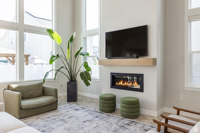 1476 W Stone Gate Dr, Saratoga Springs, UT 84045 - living area with a glass covered fireplace and baseboards