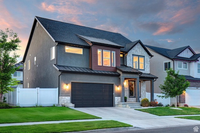 1476 W Stone Gate Dr, Saratoga Springs, UT 84045 - view of front of property with a standing seam roof, stone siding, a garage, driveway, and roof with shingles