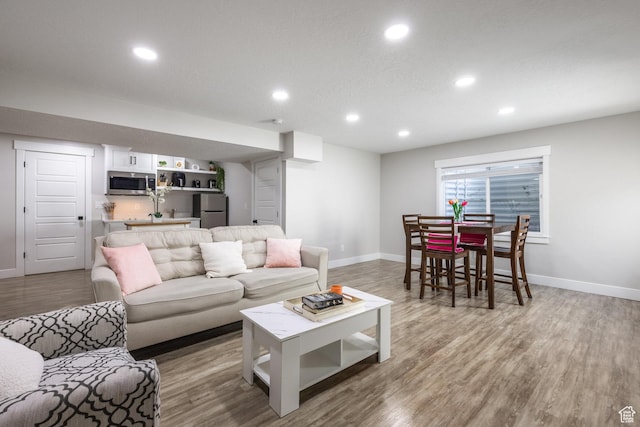 1476 W Stone Gate Dr, Saratoga Springs, UT 84045 - living room with recessed lighting, light wood-style floors, and bar