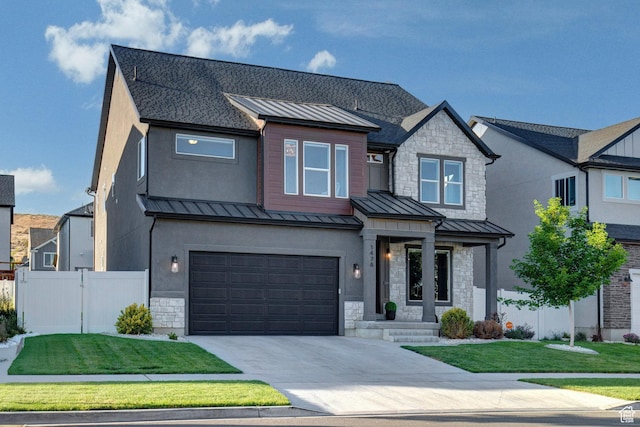 1476 W Stone Gate Dr, Saratoga Springs, UT 84045 - view of front of house featuring a standing seam roof, stone siding, driveway, a metal roof, and an attached garage
