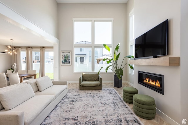 1476 W Stone Gate Dr, Saratoga Springs, UT 84045 - living area featuring a chandelier and a glass covered fireplace