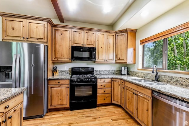 8437 Pointe Dr, Park City, UT 84098 - kitchen with black appliances, light wood-style floors, light stone counters, and beam ceiling