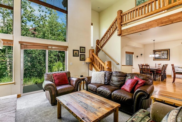 8437 Pointe Dr, Park City, UT 84098 - living room featuring stairs, a towering ceiling, and a chandelier